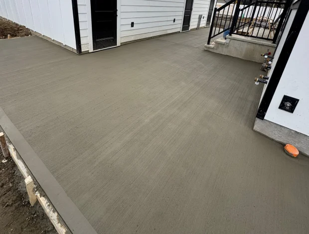 Broom finish concrete patio with smooth edges and outdoor seating potential