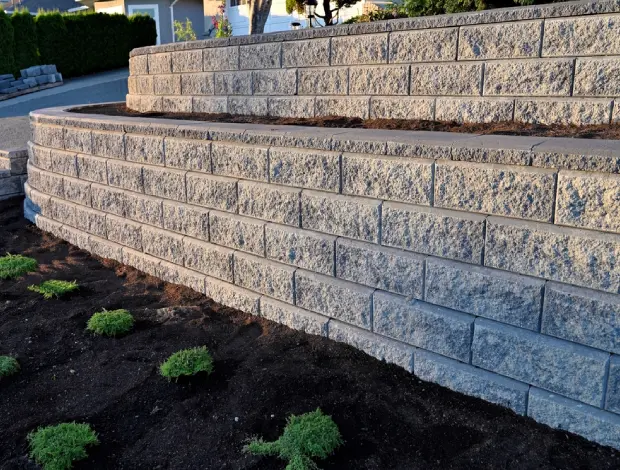 Concrete retaining wall under construction at an Edmonton property