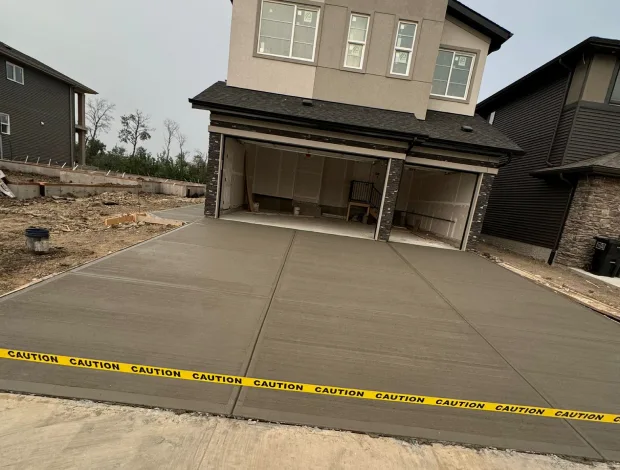Concrete driveway construction with prepared base, forms, and reinforcement