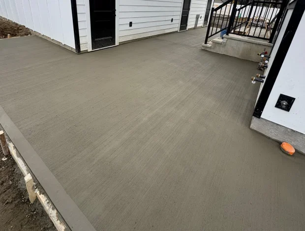 Broom finish concrete patio with smooth edges and outdoor seating potential