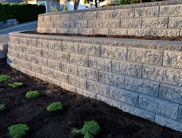 Concrete retaining wall under construction at an Edmonton property