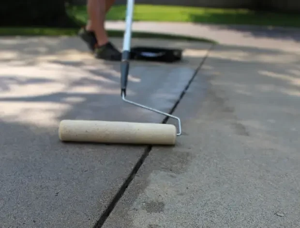 Concrete surface being sealed to protect a driveway or patio in Edmonton
