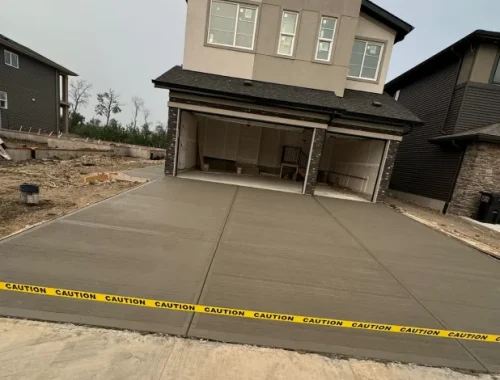 Concrete driveway construction with prepared base, forms, and reinforcement