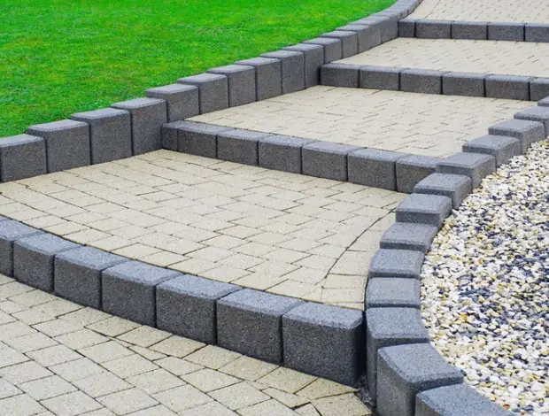 Extruded concrete landscape curbing installed along a lawn edge in Edmonton