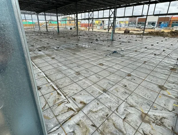 Concrete pad installation with compacted base and formed edges for residential use