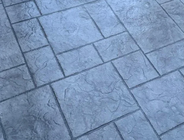 Stamped concrete driveway with decorative pattern and rich surface contrast