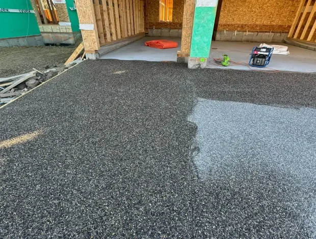 Exposed aggregate concrete driveway with a textured stone finish in Edmonton