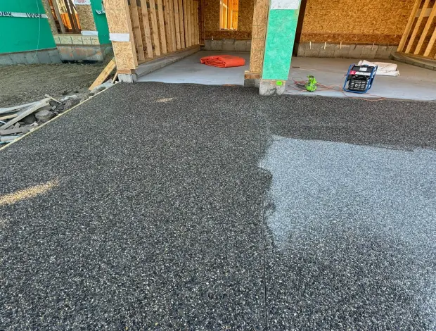 Exposed aggregate concrete driveway with a textured stone finish in Edmonton